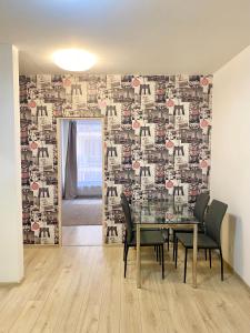 a dining room with a table and a wall mural at Budapest Opera Apartment in Budapest