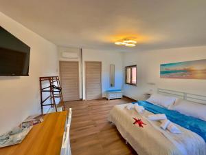 a bedroom with a large bed with towels on it at Casa del Mare in Bosa