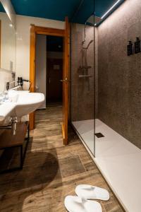 a bathroom with two sinks and a glass shower at Ushuaia, The Mountain Hotel in Arinsal