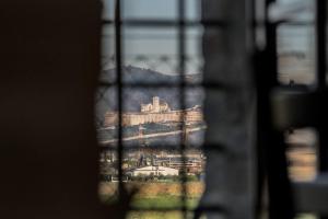 a view of a building through a window at Agriturismo - La Campagna di San Francesco in Tordandrea