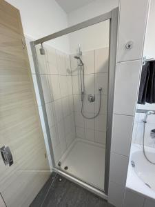 a shower with a glass door in a bathroom at Lieblingsplatz in Pfullendorf