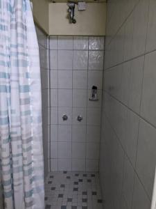 a bathroom with a shower with a shower curtain at 1BR 3BD, with Pool House Access in Old Towne