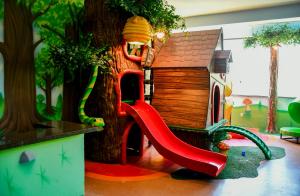 a playground with a slide and a play house at Hotel Fazenda Vista Alegre in São Lourenço