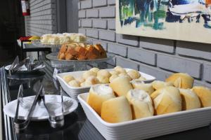 a buffet of bread and pastries on a table at Premier Hotel in Votuporanga