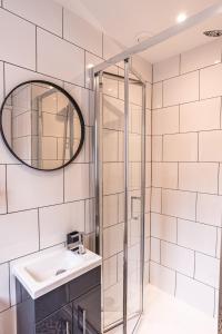 a bathroom with a sink and a shower at Larkswood Annex in Bradpole