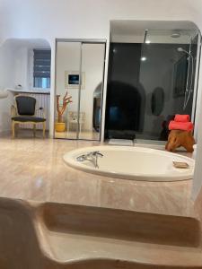 a bathroom with a bath tub in a room at Casa Matteu in Figari +15 photos
