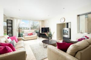 a living room with two couches and a tv at Falcon House CW73 Lower Mill Estate Cotswolds in Somerford Keynes