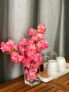 a vase filled with pink flowers on a table at Tokyo to Conakry *NONGO* in Conakry