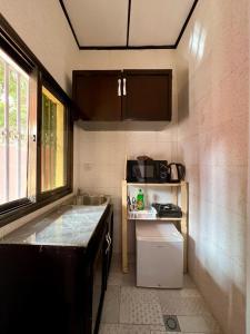 a small kitchen with a sink and a counter at Tokyo to Conakry *NONGO* in Conakry