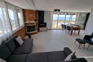 a living room with a couch and a table at Endless SEA VIEW in Lagonissi