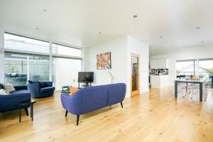 a living room with a blue couch and a table at Shelducks HM119 Lower Mill Estate The Cotswolds in Somerford Keynes