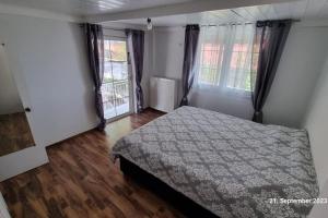 a bedroom with a bed and two windows at Endless SEA VIEW in Lagonissi