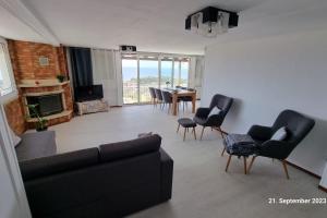 a living room with a couch and chairs and a table at Endless SEA VIEW in Lagonissi