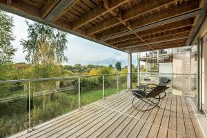 a deck with a bench and a balcony with a view at Shelducks HM119 Lower Mill Estate The Cotswolds in Somerford Keynes