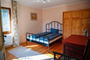 a bedroom with a bed and a dresser at Гагинската къща in Martinovo +10 photos