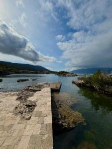 a large body of water with a dock in the water at Bay House Kakrc in Tivat