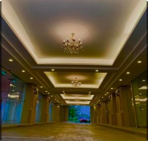 an empty hallway in a building with a chandelier at Infinity homestay @ Champs Elysees kampar in Kampar