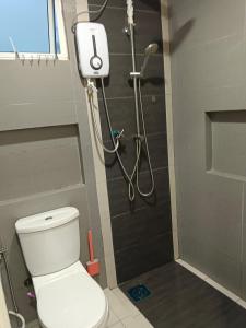 a bathroom with a shower with a toilet in it at Infinity homestay @ Champs Elysees kampar in Kampar