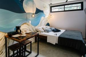 a small room with a bed and a table at Econtainer Ubatuba in Ubatuba