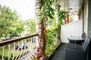 a balcony with a table and ivy on the wall at Spa Hotel at Ribby Hall Village in Wrea Green