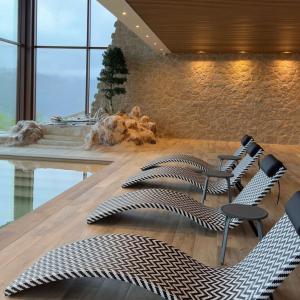 a lobby with chairs and a table with a fireplace at Encosta de Louredo by Pousadela Village in Vieira do Minho