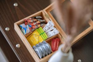 a wooden cabinet with a drawer filled with different types of books at Ktima Papaoikonomou 2 in Potos