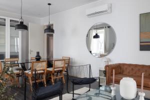 a living room with a table and chairs and a mirror at Master Deco Gem in Bairro Alto in Lisbon
