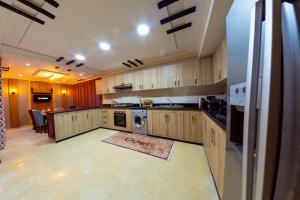 a kitchen with wooden cabinets and a washer and dryer at La casabella in Tangier
