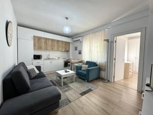 Il comprend un salon avec un canapé et une cuisine. dans l'établissement Apartment in the New Bazaar of Tirana - Hana Blu, à Tirana