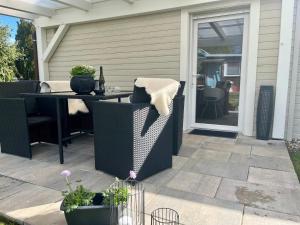 a patio with a table and chairs and a glass door at Apartment with private terrace in Friedrichshöhe