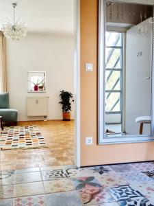 a living room with a mirror and a couch at Best Time In Graz in Graz