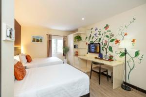 Llit o llits en una habitació de Asian Ruby Hotel Apartment - 122F Bùi Thị Xuân