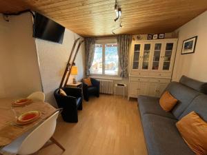 a living room with a couch and a table at Studio Les Gets, 1 pièce, 4 personnes - FR-1-623-214 in Les Gets