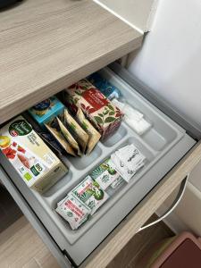 an open refrigerator with food inside of it at B&B Zelia Napoli in Naples
