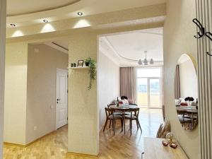 a living room with a table and a dining room at Panoramic City view Apartment with Playstation 5 in Baku