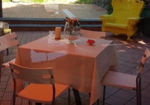 a table with a vase and chairs on a patio at Villa Grazia in Aci Catena