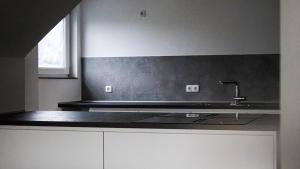 a kitchen with a sink and a counter top at Si-View Einzelzimmer mit Balkon Zimmer 3 - Hotel in Siegen