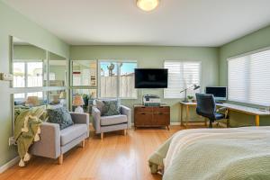 a bedroom with a bed and a desk and a tv at Charming Santa Cruz Studio with Private Hot Tub in Santa Cruz