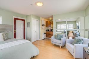 a bedroom with a bed and a couch and chairs at Charming Santa Cruz Studio with Private Hot Tub in Santa Cruz