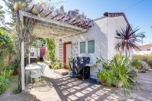 a white house with a pergola and some plants at Charming Santa Cruz Studio with Private Hot Tub in Santa Cruz