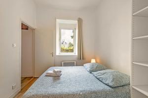 - une chambre avec un lit et une fenêtre dans l'établissement Les Capucins - T2 tout confort, à Brest