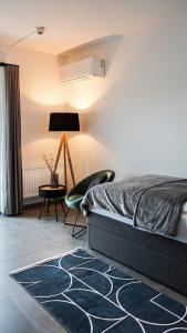ein Schlafzimmer mit einem Bett, einem Stuhl und einer Lampe in der Unterkunft Si-View Einzelzimmer mit Balkon Zimmer 3 in Siegen
