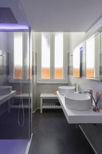 a bathroom with two sinks and two mirrors at Trevi Luxury Terrace in Rome +41 photos