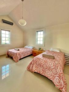 two beds in a room with two beds sidx sidx sidx at Casa Coccoloba, Chetumal, Quintana Roo in Chetumal