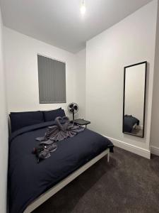 a bedroom with a large bed and a mirror at London Westminster nearby Zone1 in London