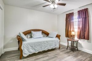 a bedroom with a bed and a ceiling fan at Peaceful Morgan City Home with Docks and Canal Access in Morgan City
