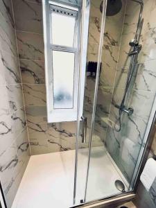 a bathroom with a shower with a window at Central London- Zone 1 - Room 3 in London