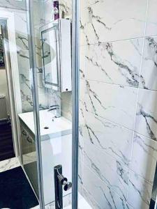a bathroom with a sink and a mirror at Central London- Zone 1 - Room 3 in London