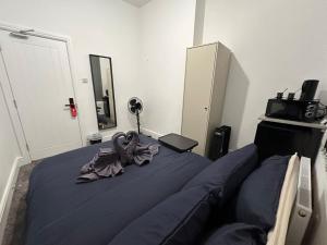 a bedroom with a bed with a towel on it at Room in Central London Zone 1 in London +4 photos