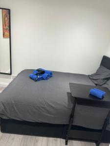 a bed with a blue bag on top of it at London Victoria Green Park 15min in London